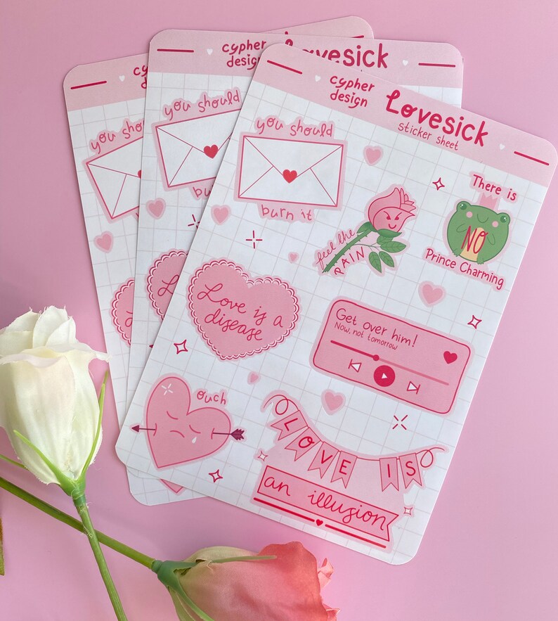 May include: A set of pink and white stickers with various designs and text. The stickers feature phrases like "Love is a disease", "Get over him!" and "Love is an illusion".