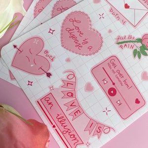 May include: A set of pink and red stickers with various romantic and humorous phrases, including "Love is a disease", "Get over him! Now, not tomorrow", "Ouch", and "Love is an illusion".