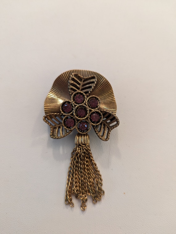 Vintage gold colored brooch with Purple faux cryst