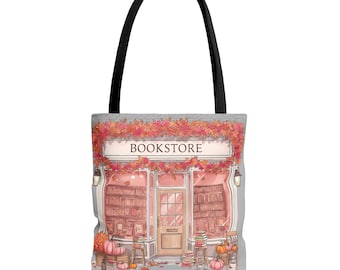May include: A tote bag featuring an illustration of a bookstore with the word "BOOKSTORE" above the entrance. The design includes fall foliage, pumpkins, and stacks of books, with a black handle.