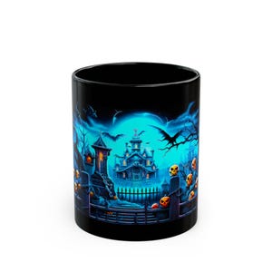 May include: Black ceramic mug featuring a spooky Halloween design. The artwork depicts a haunted house, bats, jack-o'-lanterns, and a graveyard scene in shades of blue, orange, and black. The mug is cylindrical and suitable for hot or cold beverages.