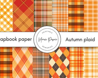 May include: A collection of scrapbook paper featuring various autumn plaid patterns in shades of orange, brown, and yellow. The text "Scrapbook paper" and "Autumn plaid" are displayed. The Memoir Paperie Memories logo is in the center.