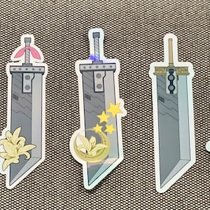 May include: Eight different stickers featuring a silver sword with various designs. The designs include a flower, a crescent moon, stars, and a rainbow.