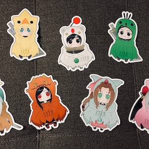 May include: Seven colorful cartoon character stickers with different animal costumes. Each sticker features a character with a sword and a unique animal hood. The characters are wearing a variety of costumes, including a chicken, a bear, a frog, a dragon, a cat, a bunny, and a pink creature.