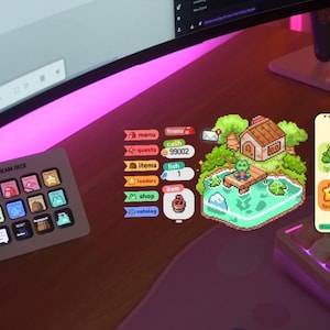 May include: A desk setup featuring a Stream Deck, a curved monitor, and a phone displaying a "fishphone" app. The app has colorful icons and a pixelated frog scene. The Stream Deck has multiple buttons with various icons.
