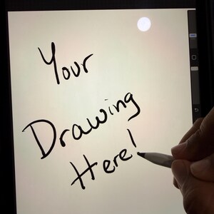 May include: A digital tablet screen displaying the words "Your Drawing Here!" in black handwritten font. A stylus is poised to draw on the screen. The tablet is black.