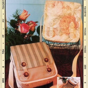 May include: Two fabric mail bags with straps. One bag is striped in pink and green, the other has a floral pattern with pink roses. Both bags have a flap with button closures. The text "A Mail Bag" is printed below the bags.