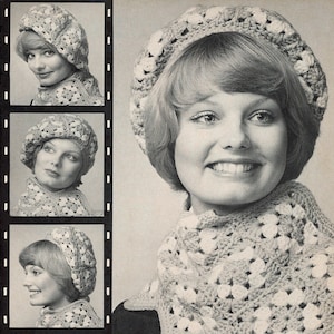 May include: A black and white photo of a woman wearing a crocheted beret and scarf. The beret and scarf are made with a white and gray yarn. The woman is smiling and looking at the camera.