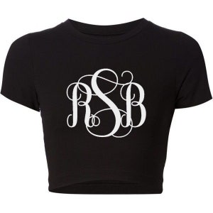 May include: A black cropped t-shirt with a white monogram of the letters "RSB" in a script font.