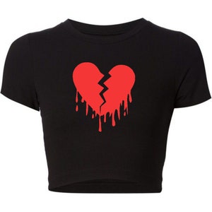 May include: Black cropped t-shirt with a red dripping broken heart graphic.
