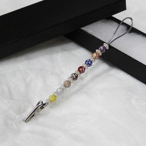 Festive beaded bracelet and jewelry helper with satin strap.