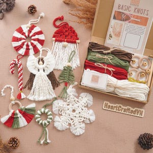 May include: A selection of handmade macrame Christmas decorations in red, white, and green. Includes a candy cane, angel, wreath, snowflake, and gnome. A box set with macrame supplies is also shown.