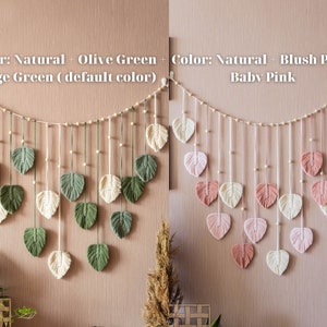 May include: Two macrame wall hangings with a string of wooden beads. The first wall hanging features leaves in shades of green and natural white. The second wall hanging features leaves in shades of pink and natural white. The text "Color: Natural + Olive Green + Sage Green (default color)" is above the first wall hanging. The text "Color: Natural + Blush Pink + Baby Pink" is above the second wall hanging.