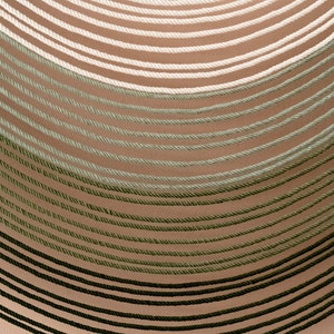 May include: A close-up of a wall with a gradient of green, white, and beige rope. The rope is arranged in a curved pattern, creating a visual effect of depth and texture.