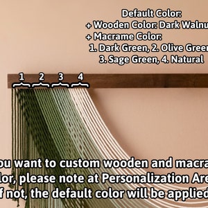 May include: A wooden wall hanging with four strands of macrame cord in shades of green and natural white. The wood is dark walnut. The macrame cord is labeled 1. Dark Green, 2. Olive Green, 3. Sage Green, 4. Natural.