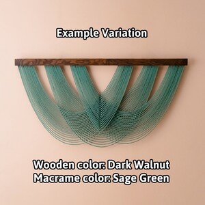 May include: A wall hanging featuring a dark walnut wooden bar with sage green macrame cords draped in a layered, scalloped pattern. The text "Example Variation", "Wooden color: Dark Walnut", and "Macrame color: Sage Green" is visible.