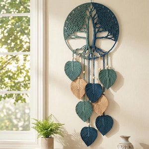 May include: A macrame wall hanging featuring a tree of life design. The circular piece is in shades of teal and blue, with leaf-shaped accents in teal and tan. Wooden beads are incorporated into the design, adding a natural touch to this home decor item.