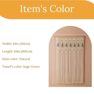 May include: A natural-colored macrame wall hanging with sage green tassels. It measures 44 inches wide by 64 inches long (110 cm x 160 cm).