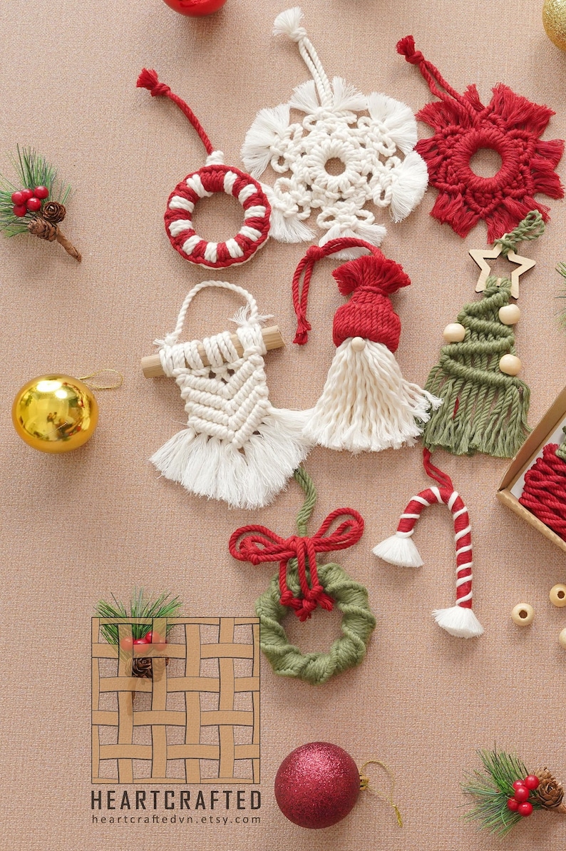 May include: A collection of handmade Christmas ornaments made with macrame. The ornaments include a snowflake, a wreath, a candy cane, a gnome, a Christmas tree, and a circle with red and white stripes. The ornaments are all made with natural fibers and have a rustic, handmade look.