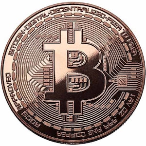 May include: A copper-colored Bitcoin coin with the Bitcoin logo and the text "1AV OZ 999 FINE COPPER" and "BITCOIN DIGITAL DECENTRALIZED PEER TO PEER" around the edge.