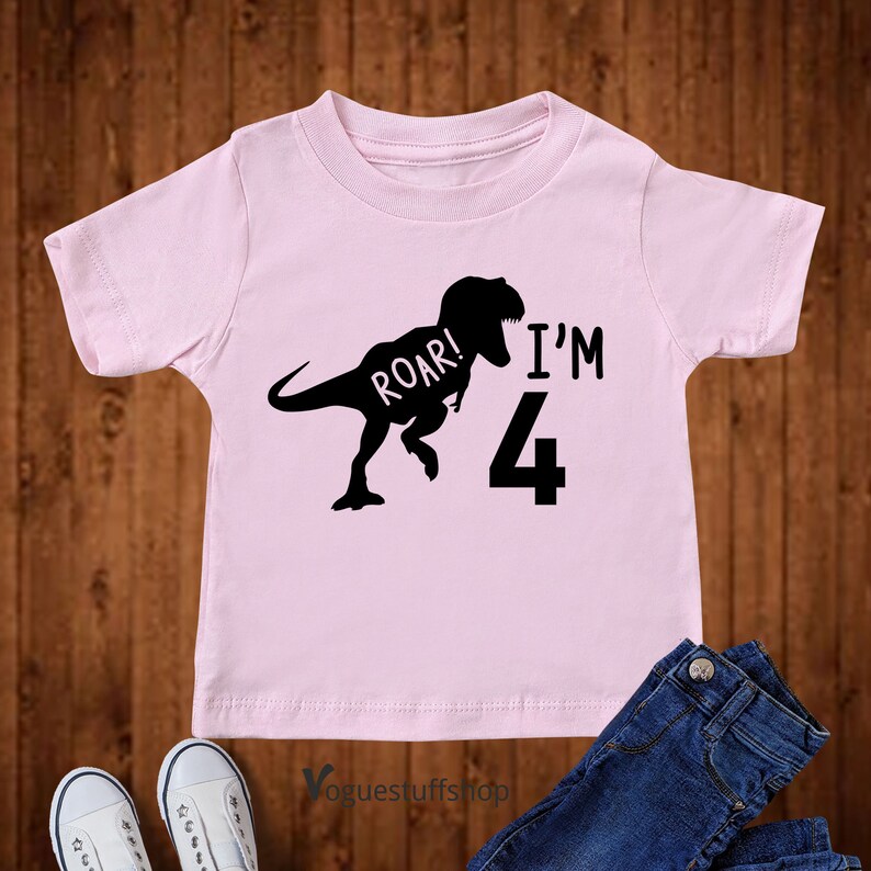 May include: Pink short-sleeved t-shirt with a black dinosaur silhouette and the text "Roar! I'm 4".