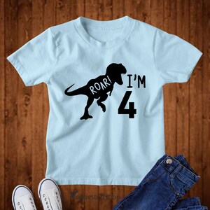May include: Light blue t-shirt with a black dinosaur silhouette and the text "Roar! I'm 4".
