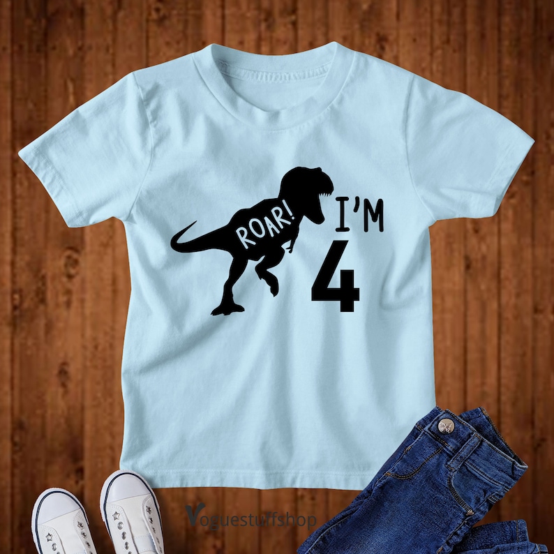May include: Light blue t-shirt with a black dinosaur silhouette and the text "Roar! I'm 4".