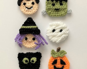 May include: A collection of six handmade crochet Halloween-themed appliques. The set includes a boy, Frankenstein's monster, a witch, a mummy, a black cat, and a jack-o'-lantern. Each applique features detailed stitching and vibrant colors, perfect for crafting projects.