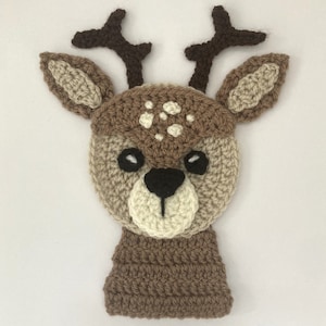 May include: A brown crocheted deer head with white spots, brown antlers, and black eyes.