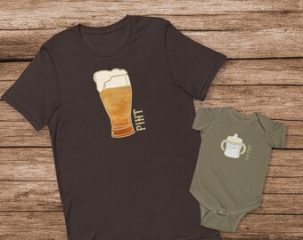 May include: A matching set of two t-shirts, one for an adult and one for a baby. The adult t-shirt is dark brown and features a graphic of a glass of beer with the word "PINT" written vertically next to it. The baby t-shirt is olive green and features a graphic of a baby bottle with the text "1/2 PINT" written next to it.