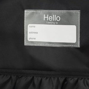 May include: A black backpack with a clear plastic name tag that says "Hello I belong to" with spaces for name, address, and phone number.