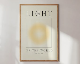 May include: A framed print with a light yellow sunburst design and the text "LIGHT OF THE WORLD" with the scripture reference "Matthew 5:14" below.