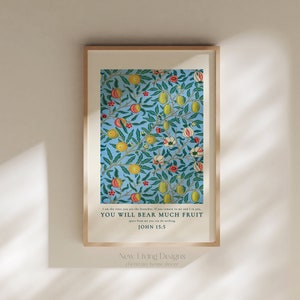 May include: A framed print with a blue background and a floral pattern of green leaves, yellow lemons, and red flowers. The print includes the text "I am the vine, you are the branches. If you remain in me and I in you, you will bear much fruit. John 15:5" and the text "New Living Designs, Christian home decor".