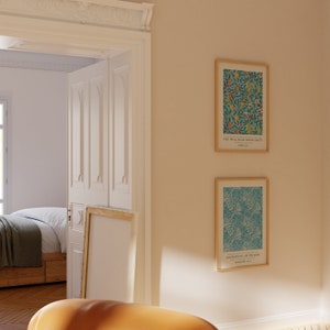 May include: Two framed prints with floral patterns and inspirational quotes. The top print features a blue background with yellow, red, and green flowers and the quote "You will bear much fruit." John 15:8. The bottom print features a blue background with a green and white floral pattern and the quote "Sacrifice of Praise" Hebrews 13:15.