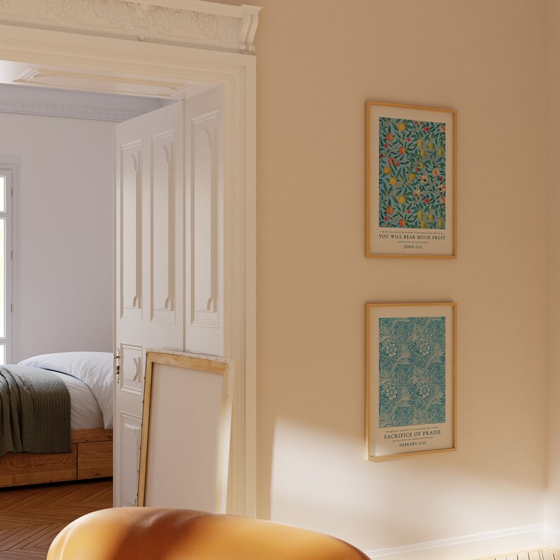 May include: Two framed prints with floral patterns and inspirational quotes. The top print features a blue background with yellow, red, and green flowers and the quote "You will bear much fruit." John 15:8. The bottom print features a blue background with a green and white floral pattern and the quote "Sacrifice of Praise" Hebrews 13:15.