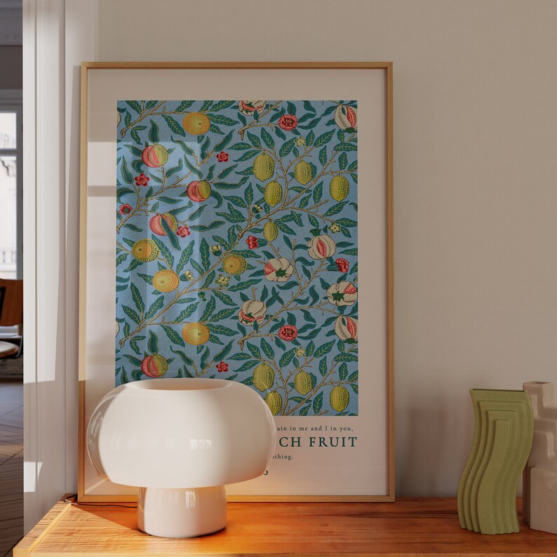 May include: A framed poster with a blue background and a repeating pattern of lemons, flowers, and leaves. The text at the bottom of the poster reads "Sin is in me and if in you, Such Fruit, Nothing."