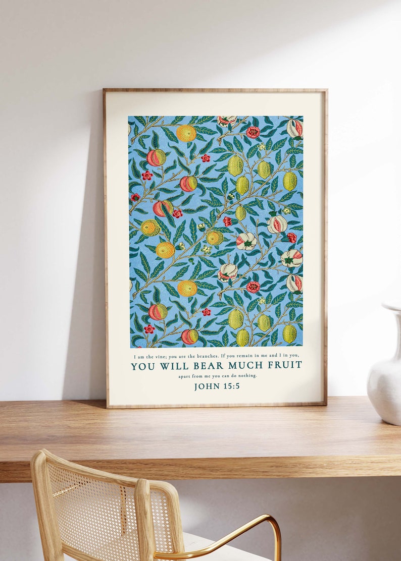 May include: A framed print with a blue background and a repeating pattern of green leaves, yellow lemons, and pink and red flowers. The print features a quote from the Bible, John 15:5, which reads: "I am the vine, you are the branches. If you remain in me and I in you, YOU WILL BEAR MUCH FRUIT apart from me you can do nothing."