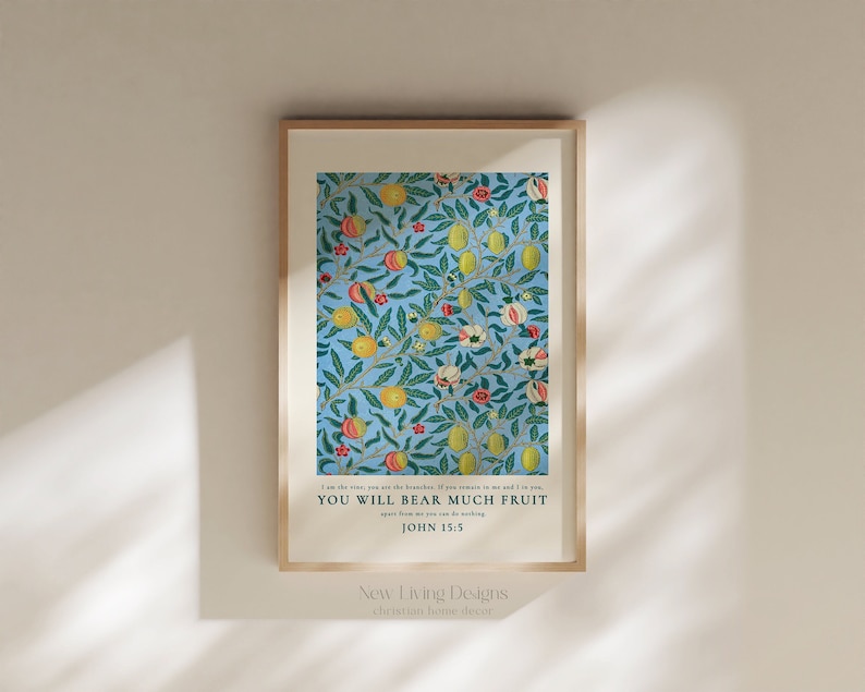 May include: A framed print with a blue background and a floral pattern of green leaves, yellow lemons, and red flowers. The print includes the text "I am the vine, you are the branches. If you remain in me and I in you, you will bear much fruit. John 15:5" and the text "New Living Designs, Christian home decor".