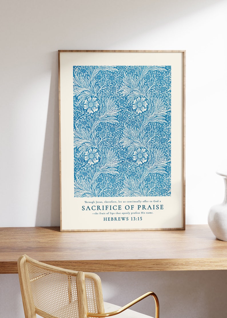 May include: A framed print with a blue floral pattern and a white background. The print features a quote from Hebrews 13:15, "Through Jesus, therefore, let us continually offer to God a sacrifice of praise - the fruit of lips that openly profess His name."