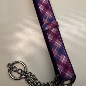 May include: Purple and blue plaid dog collar with a silver chain and two silver rings.