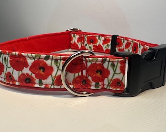 May include: Red dog collar with a white poppy flower pattern and a black buckle.