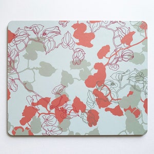 May include: A light blue placemat with a floral pattern. The pattern features red and grey leaves and vines.