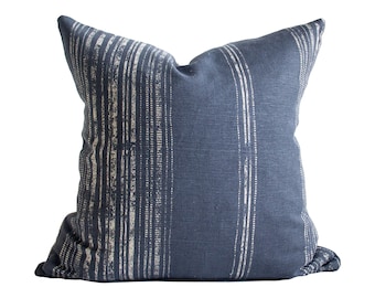 May include: A blue and white striped throw pillow with a subtle sheen. The pillow is made of a soft, textured fabric and has a simple, modern design.