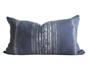 May include: A blue and white striped throw pillow with a linen texture.
