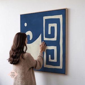 May include: A framed abstract artwork featuring a blue backdrop with cream-coloured geometric shapes. The rectangular art piece is mounted in a natural wood frame. The text "Printed, Framed & Shipped to you!" is in the lower left corner.