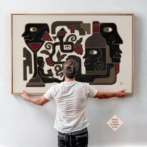 May include: Abstract art print with a wine theme, featuring figures, a bottle, and grapes in black, brown, and red. The artwork is framed in a natural wood tone.