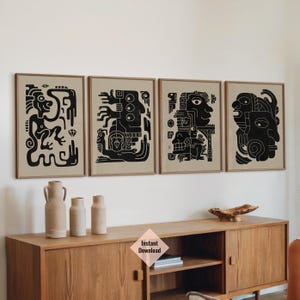 May include: Set of three black and white abstract art prints with geometric patterns and stylized figures. The prints are framed and hung on a beige wall above a wooden cabinet.