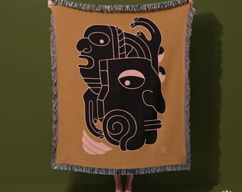 Coperta in cotone intrecciato con volti astratti: decorazione boho in terracotta azteca
