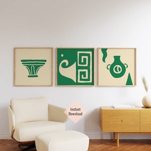 May include: Three framed prints with a cream background and green geometric designs. The designs include a stylised vase, a column, and a horn with a Greek key pattern.