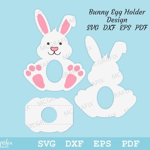 May include: A white bunny egg holder design with pink ears and paws. The design is available in SVG, DXF, EPS, and PDF formats. Bunny Egg Holder Design SVG DXF EPS PDF
